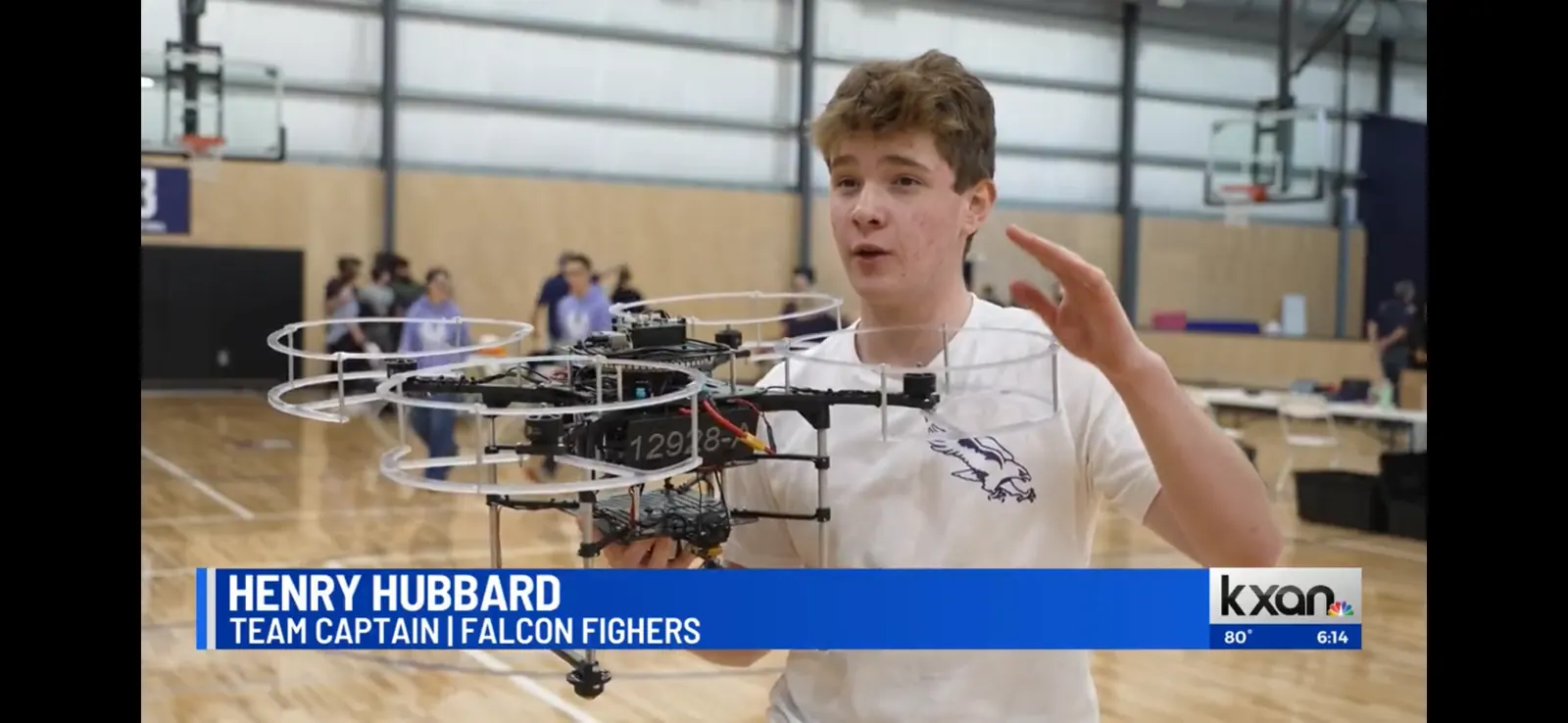 Henry featured on a KXAN news segment as drone team captain, holding his drone